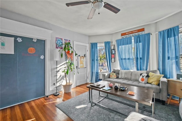 living room featuring hardwood / wood-style floors and ceiling fan