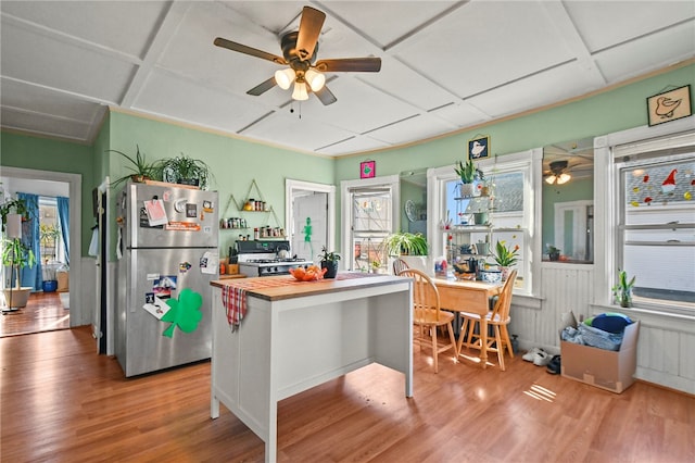 kitchen featuring hardwood / wood-style floors, butcher block countertops, ceiling fan, and stainless steel fridge