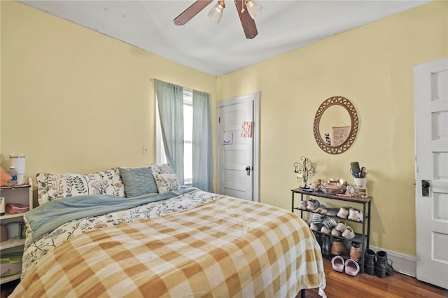 bedroom with hardwood / wood-style flooring and ceiling fan