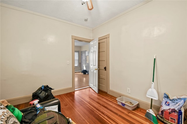 miscellaneous room with ceiling fan, hardwood / wood-style flooring, and ornamental molding