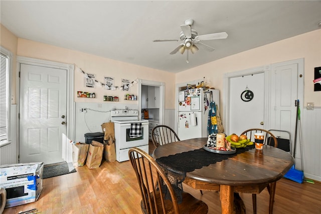 dining area featuring light wood-type flooring and ceiling fan