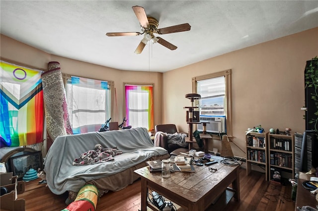 living room featuring cooling unit, hardwood / wood-style flooring, and ceiling fan