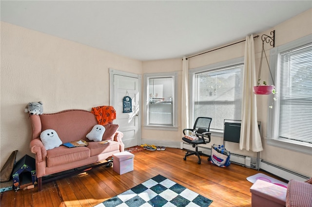 interior space featuring wood-type flooring and baseboard heating