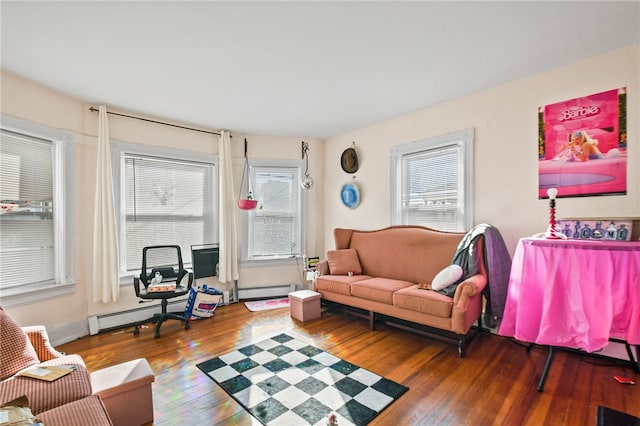 living room with a baseboard radiator, hardwood / wood-style floors, and plenty of natural light