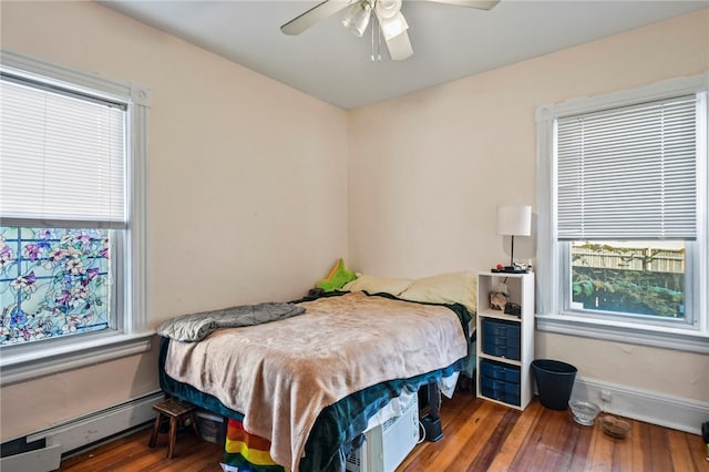 bedroom featuring a baseboard radiator, dark wood-type flooring, and ceiling fan