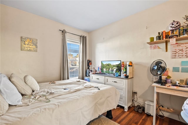 bedroom with dark hardwood / wood-style floors