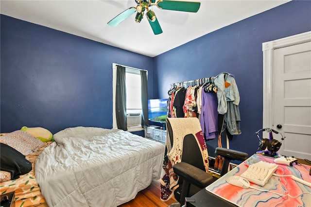 bedroom with ceiling fan and wood-type flooring