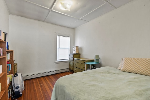 bedroom with dark wood-type flooring and baseboard heating