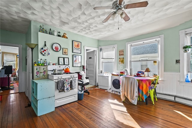 kitchen featuring hardwood / wood-style floors, white range with gas stovetop, and a wealth of natural light