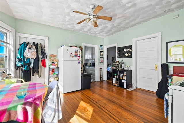 kitchen with hardwood / wood-style flooring, ceiling fan, and white fridge