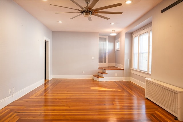 empty room featuring ceiling fan and radiator