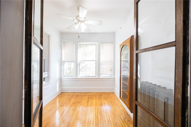 sunroom featuring ceiling fan