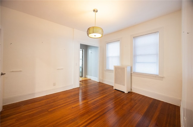 spare room featuring dark hardwood / wood-style floors