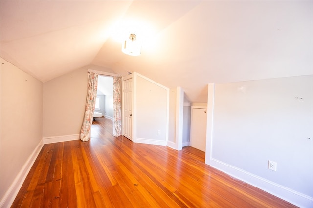 bonus room featuring lofted ceiling and wood-type flooring