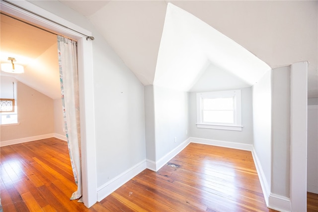 bonus room featuring hardwood / wood-style floors and lofted ceiling