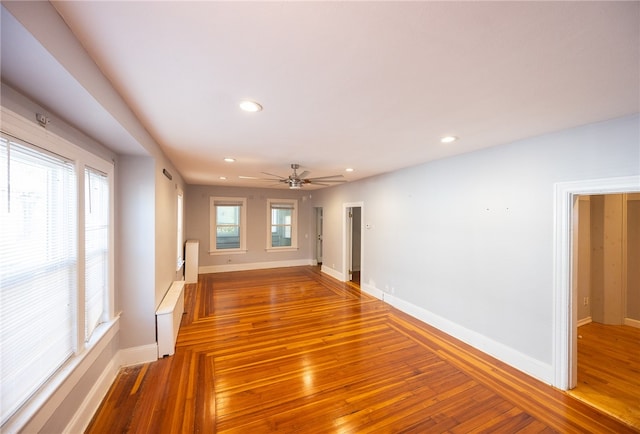 empty room with wood-type flooring and ceiling fan