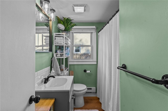 bathroom featuring hardwood / wood-style floors, vanity, toilet, and baseboard heating