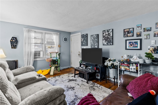 living room featuring a textured ceiling, cooling unit, and dark hardwood / wood-style floors