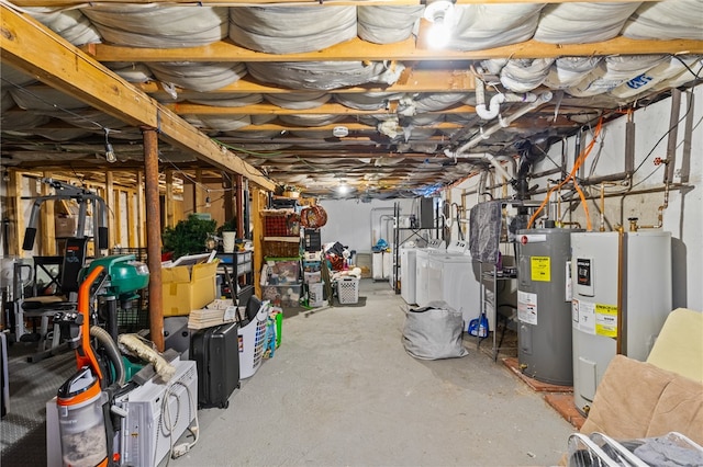 basement with electric water heater and washing machine and dryer