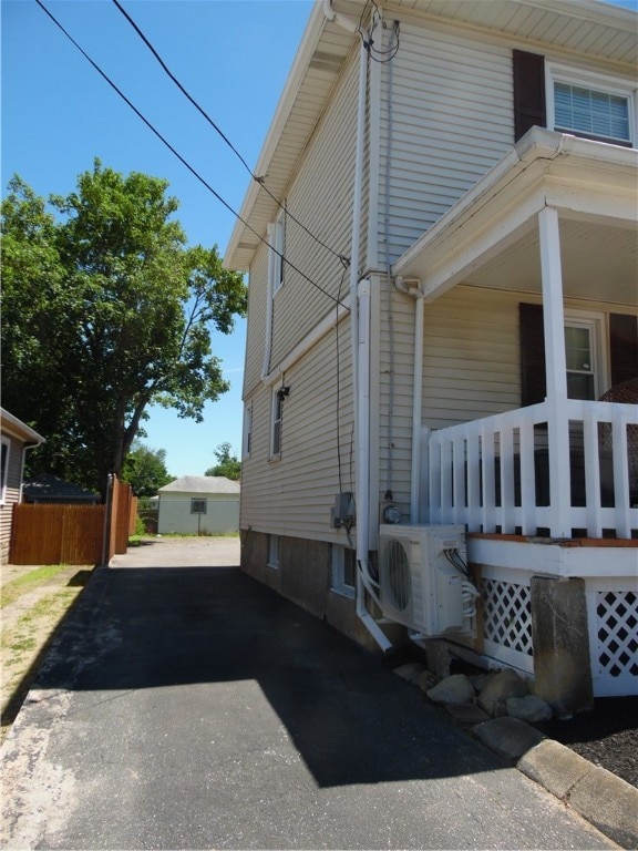 view of home's exterior featuring ac unit and a porch