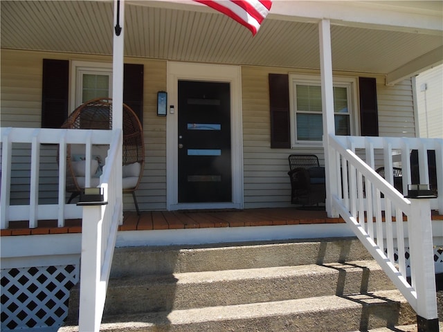 view of exterior entry with a porch