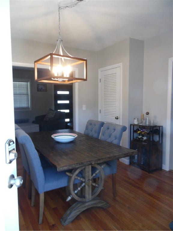 dining room featuring dark hardwood / wood-style floors and a chandelier