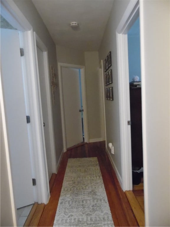 corridor with dark hardwood / wood-style floors