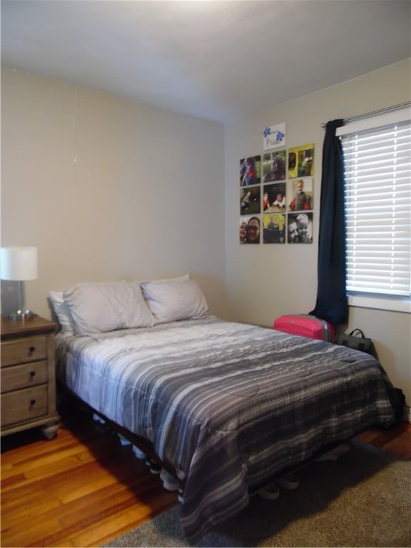 bedroom with wood-type flooring