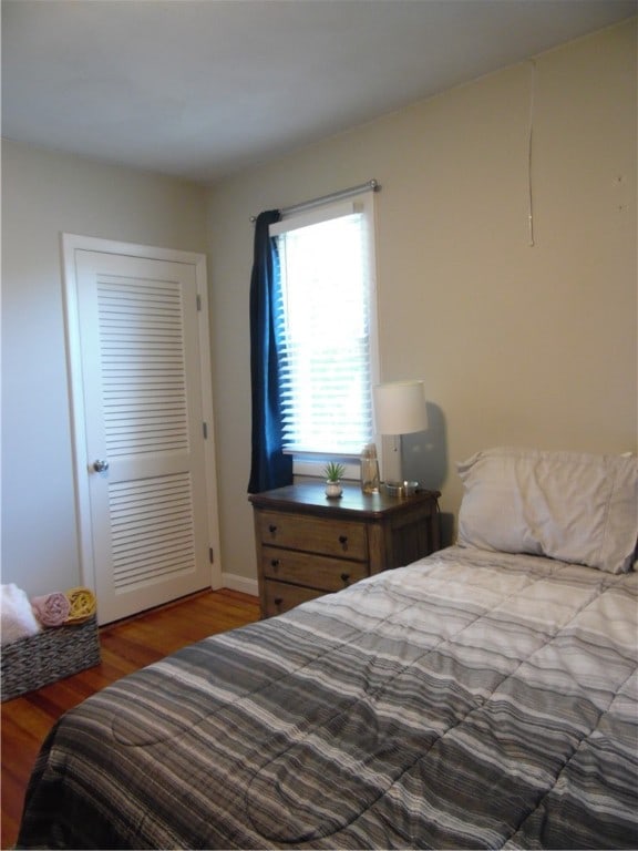 bedroom with a closet and hardwood / wood-style flooring