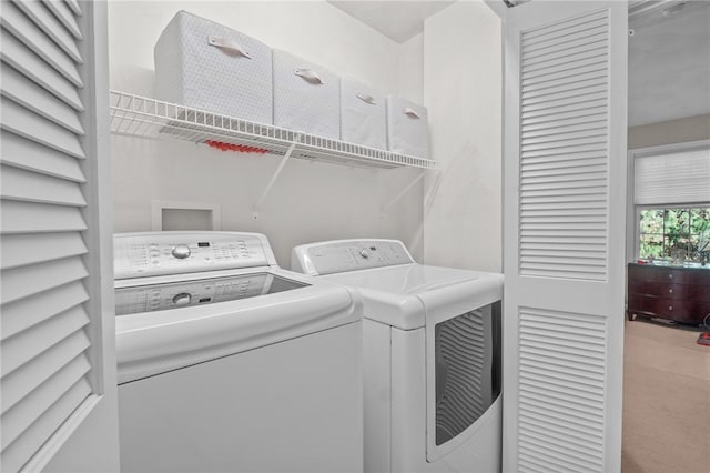 clothes washing area featuring carpet flooring and separate washer and dryer