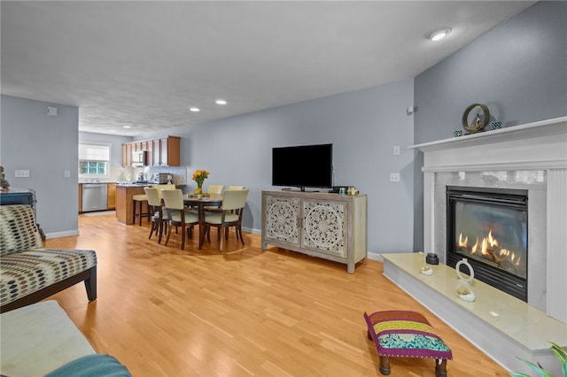 living room with a fireplace and light hardwood / wood-style flooring