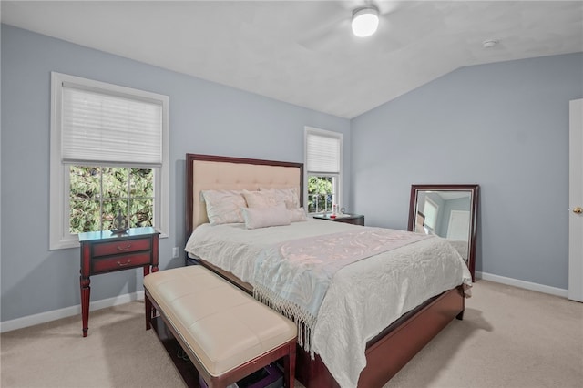 bedroom featuring multiple windows, ceiling fan, and light carpet