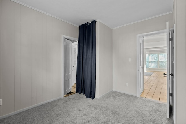 carpeted spare room with crown molding