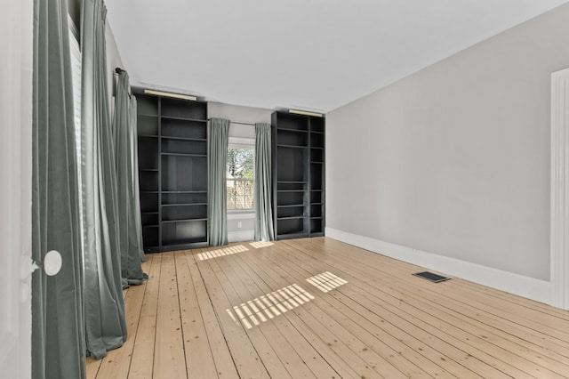 unfurnished room with light hardwood / wood-style flooring