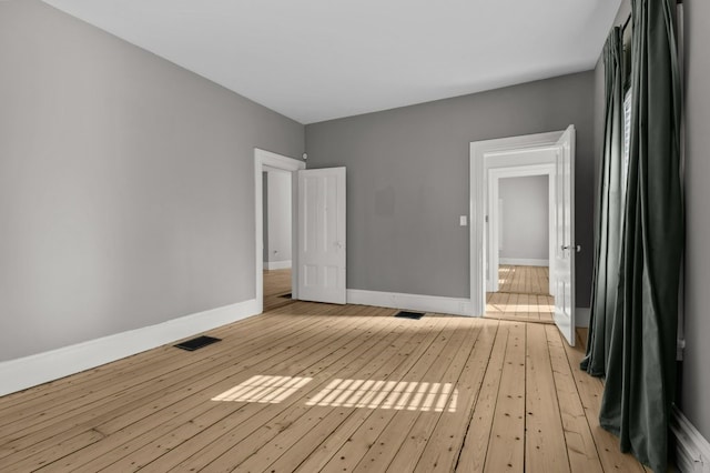 spare room featuring light wood-type flooring