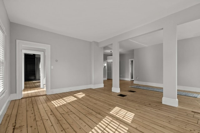 empty room with light hardwood / wood-style flooring