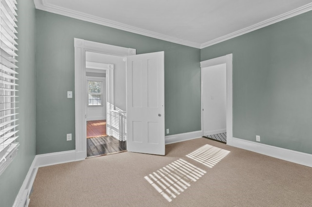 unfurnished bedroom featuring carpet flooring and crown molding