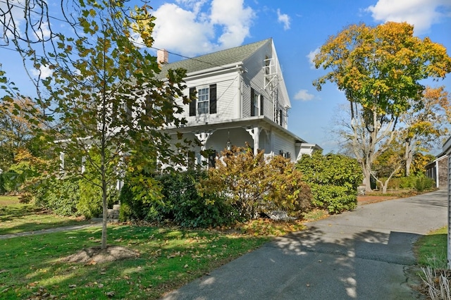 view of side of home featuring a yard