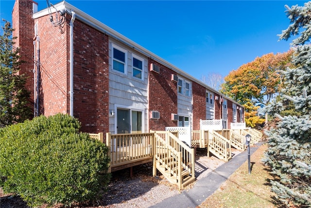 back of house featuring a wooden deck