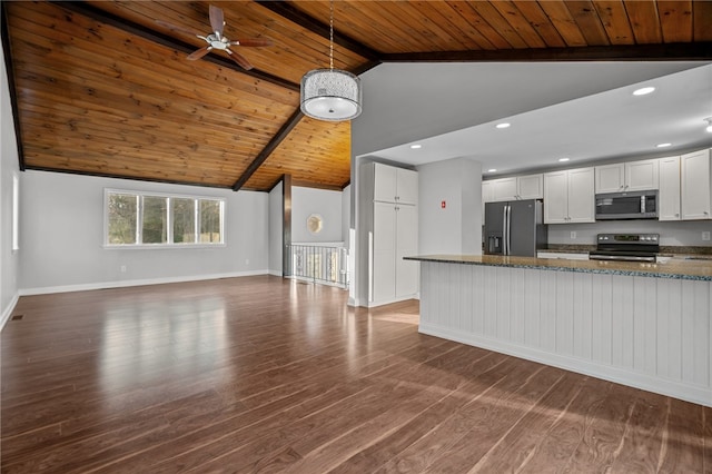 kitchen featuring dark hardwood / wood-style flooring, white cabinetry, appliances with stainless steel finishes, and beam ceiling