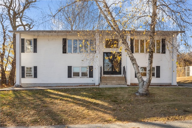 split foyer home featuring a front lawn