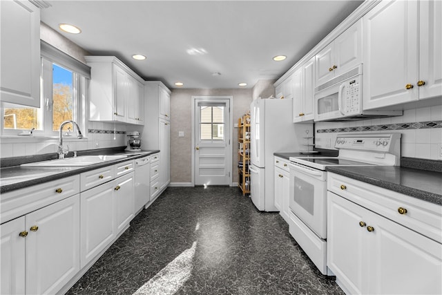 kitchen with white cabinetry, white appliances, and sink