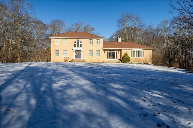 view of snow covered rear of property