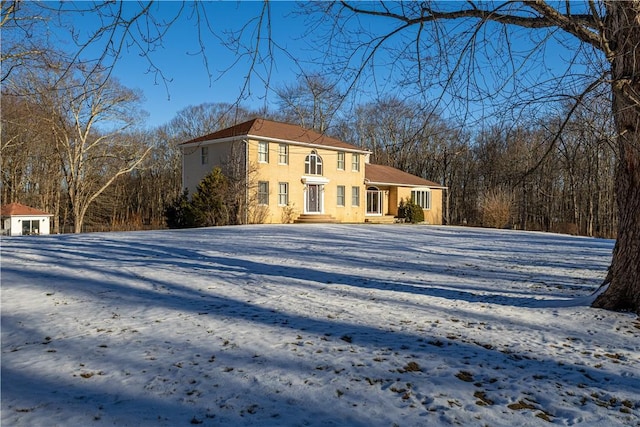 view of snowy exterior with an outdoor structure