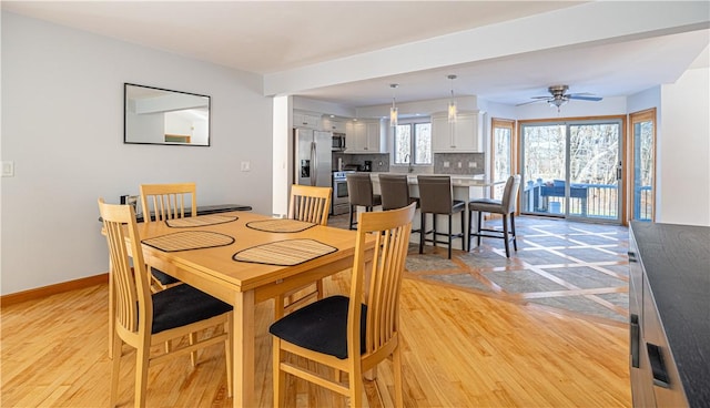 dining room with light wood-type flooring and ceiling fan