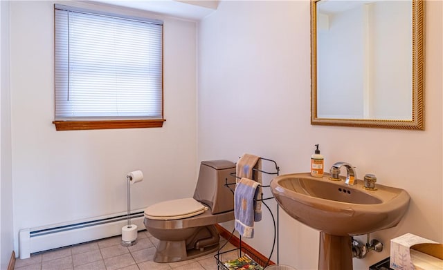 bathroom with toilet, a baseboard radiator, and tile patterned floors