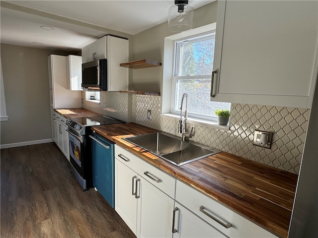 kitchen with wooden counters, stainless steel appliances, dark wood-type flooring, sink, and white cabinetry