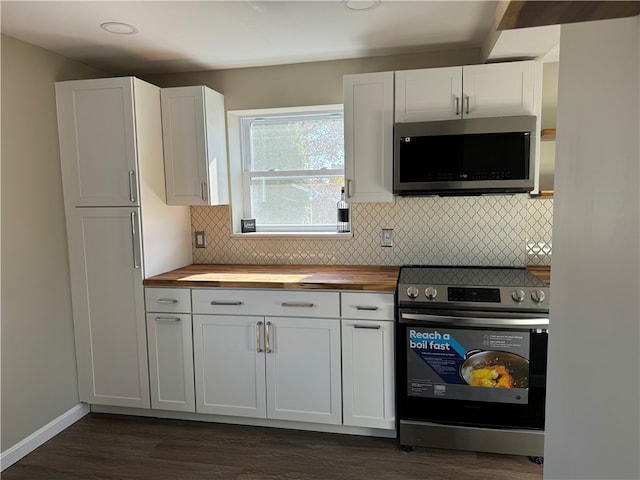 kitchen featuring white cabinetry, stainless steel appliances, butcher block counters, and dark hardwood / wood-style floors