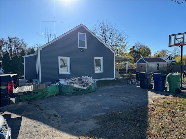 view of home's exterior featuring a carport and a storage shed