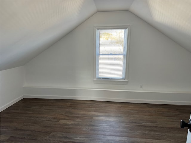 bonus room featuring dark wood-type flooring and lofted ceiling